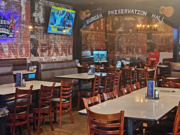Burger Preservation Hall painted on the wall over tables and chairs