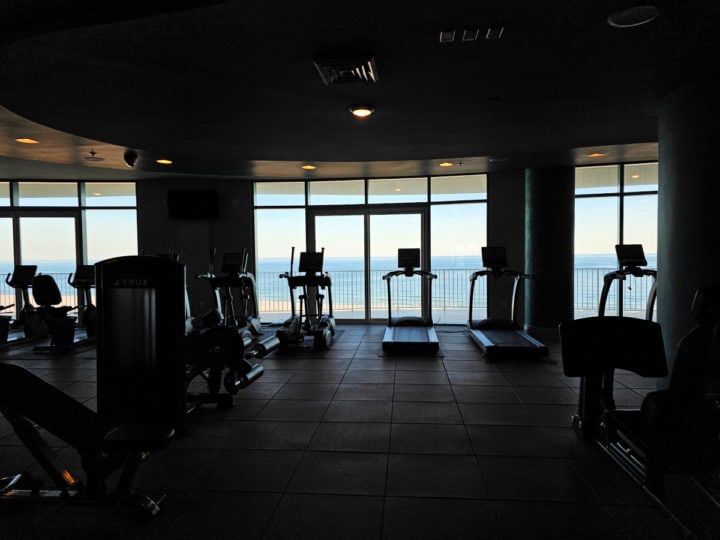 treadmills and gym equipment lined up with a view of the Gulf of Mexico 