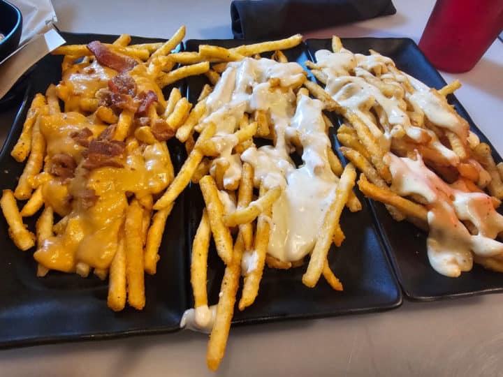Flight of fries with three different toppings