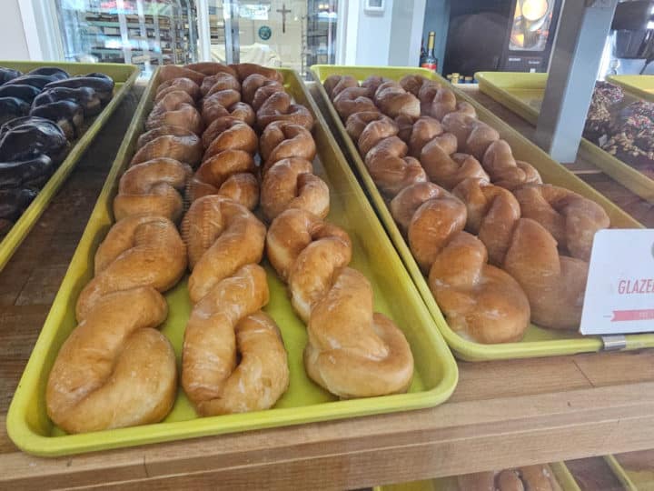 Glazed twist donuts on a yellow tray