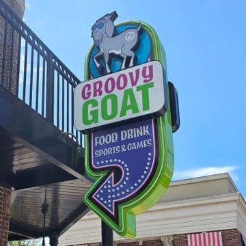 Groovy Goat sign with a goat and food drink next to a large arrow