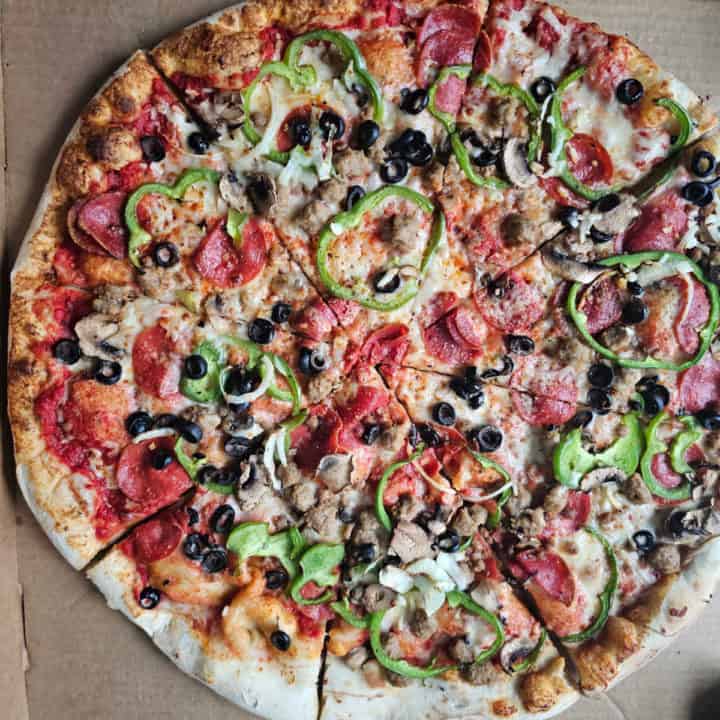 Large pizza with mushrooms, green peppers, pepperoni, black olives