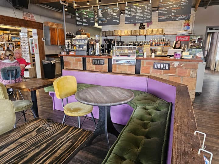 purple bench with tables and chairs in front of the Latte Da coffee counter