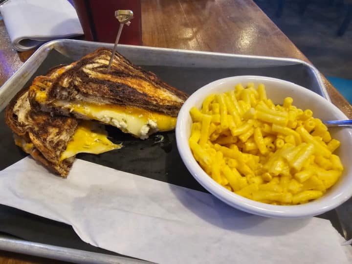 grown up grilled cheese next to kraft mac and cheese on a silver tray