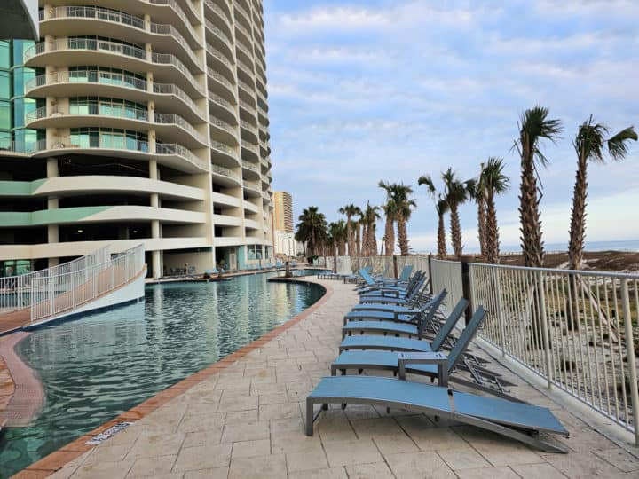 outdoor pool and lounge chairs with Turquoise Place condo building in the background