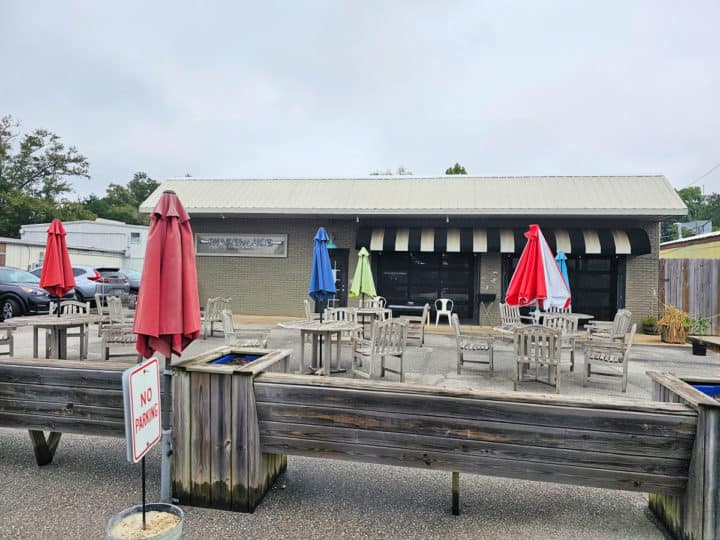 outdoor tables and chairs in front of Warehouse Bakery and Donuts