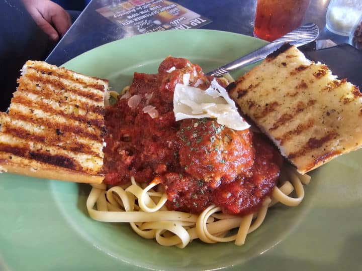 Spaghetti and meatballs on a plate with garlic bread