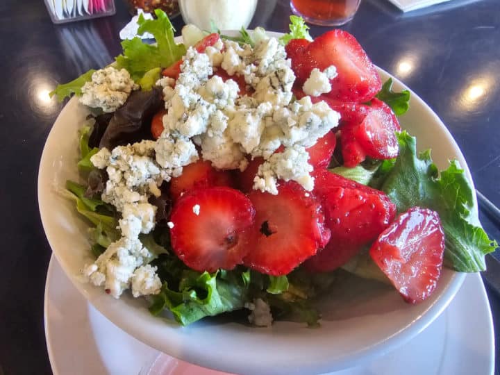 Strawberry and blue cheese salad in a white bowl