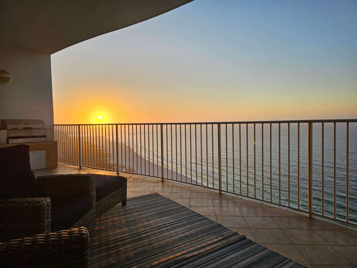sunrise from balcony with outdoor furniture
