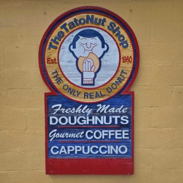 The Tatont shop sign with fresh made doughnuts, gourmet coffee, cappuccino
