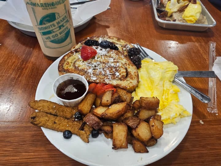The weekender with cinnamon roll french toast, eggs, tempeh bacon, and potatoes