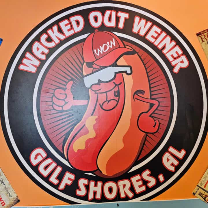 Wacked Out Weiner Gulf Shores sign with a hot dog wearing a WOW hat