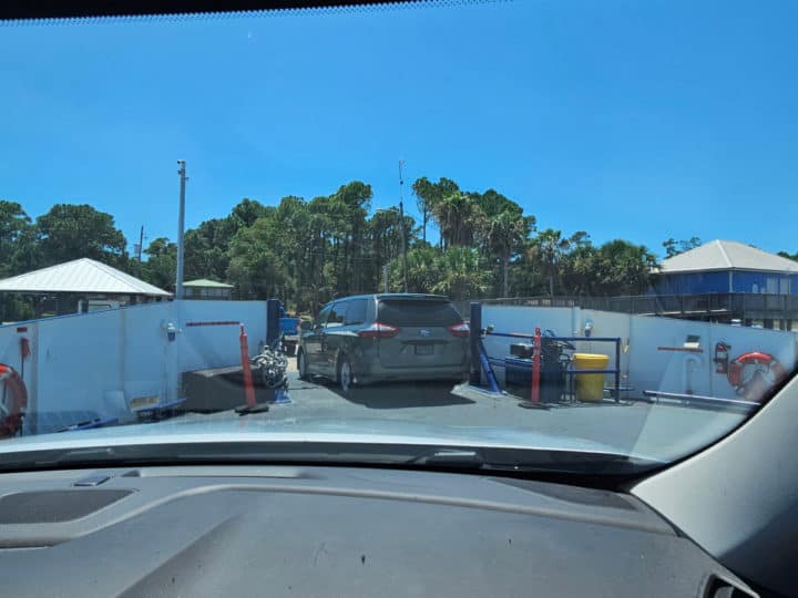 Minivan driving off the front of a ferry 