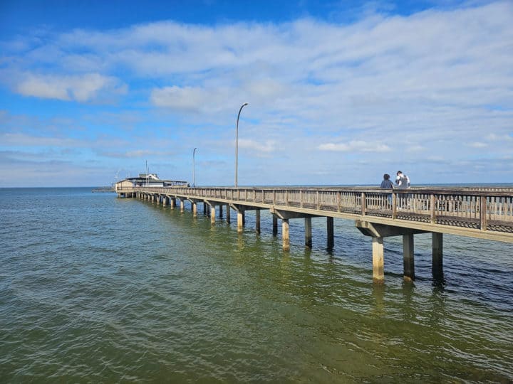 Fairhope pier stretching over the water with people walking on it