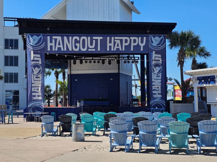 Hangout Happy sign over the stage with Adirondack chairs lined up in front of it