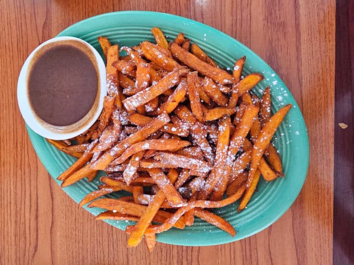 Sweet potato fries with dipping sauce on a turquoise plate