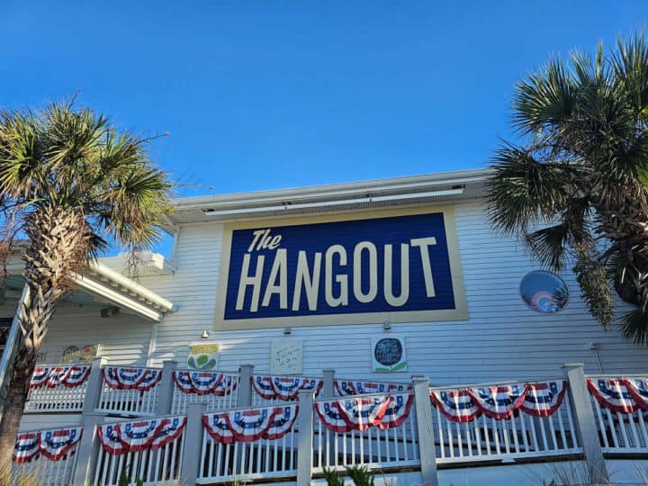 The Hangout sign over a white walkway with flag decorations