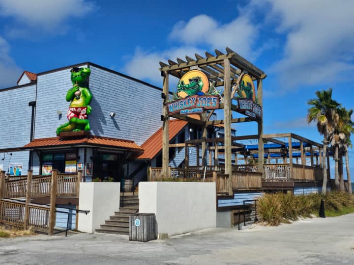 Exterior of Whiskey Joe's Bar and Grill with gator on the building