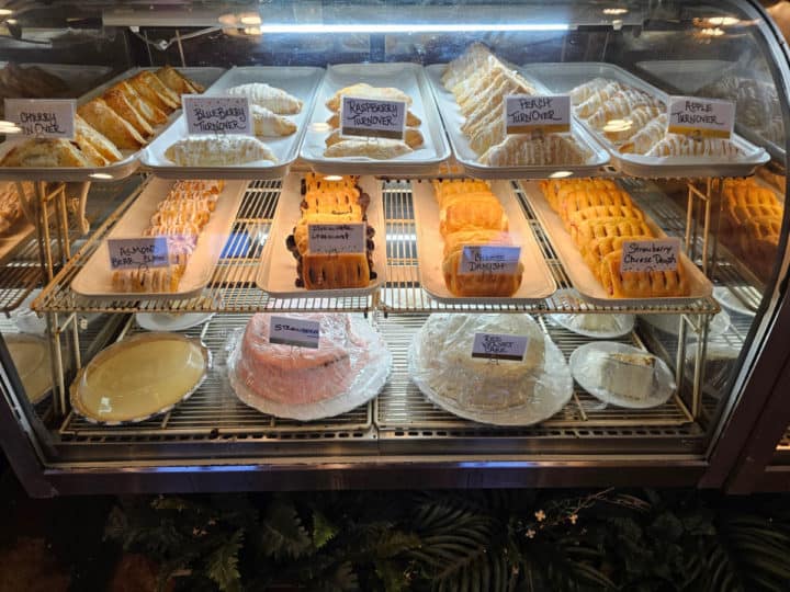 bakery case with cake slices, turnovers, and more
