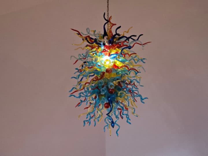 brightly colored glass chandelier hanging from the ceiling 