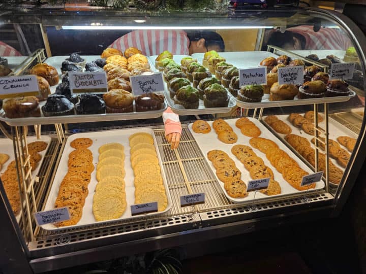 cookies and muffins lined in a bakery case