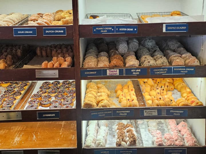 donuts on trays in an open display 