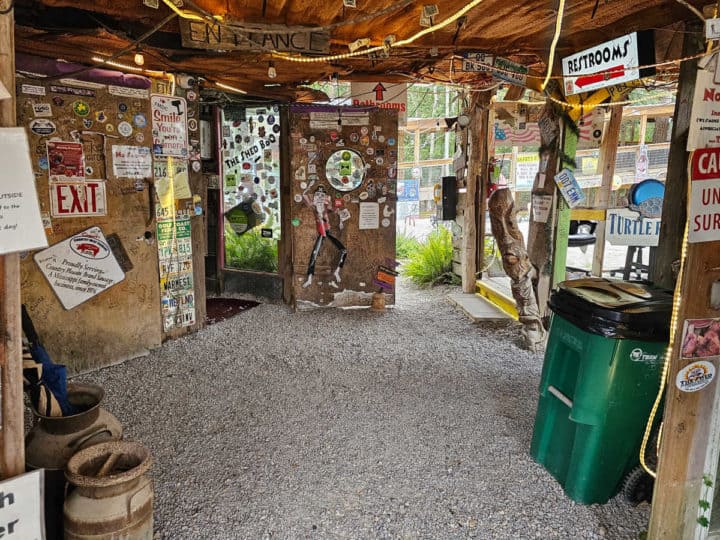 gravel entrance with open doors and an entrance sign