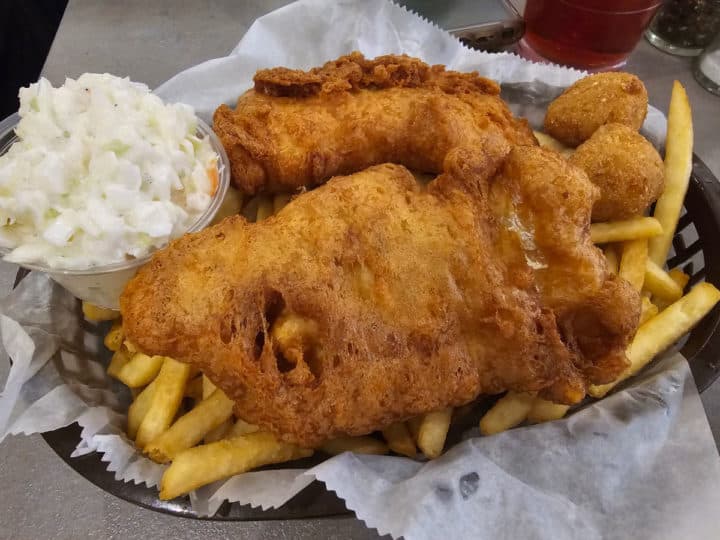 Fish and chips in a basket with coleslaw