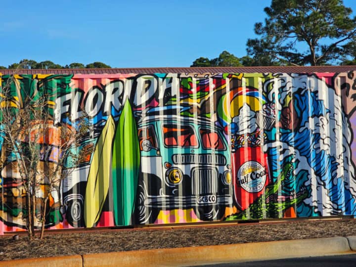 Shipping container painted with Florida, a Gulf Coast burger Co shake, alligator, and waves