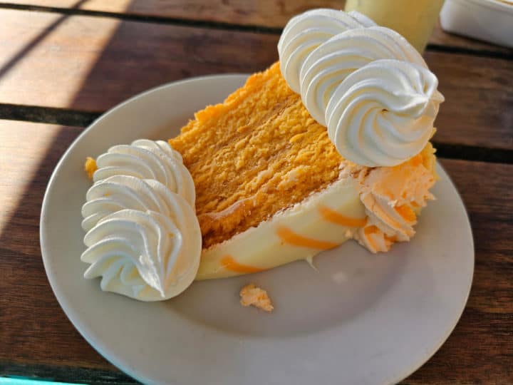 orange layered cake with whipped cream