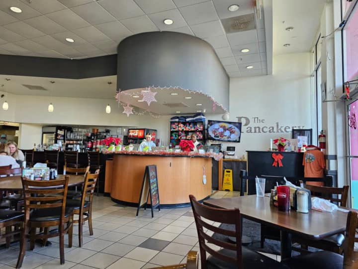 indoor restaurant seating with The Pancakery on the wall