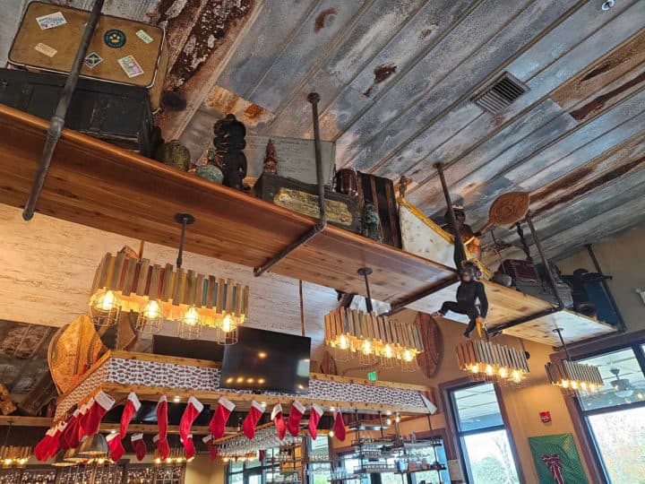 monkey decorations and boxes above a lit bar