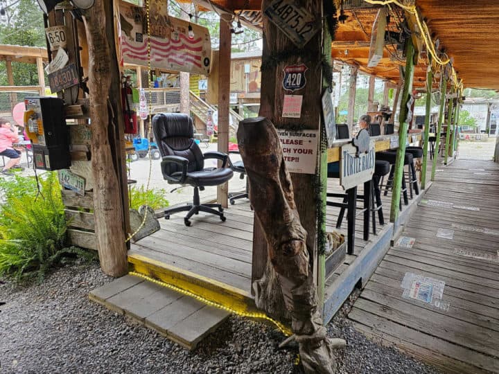 outdoor seating at a wooden bar on a boardwalk