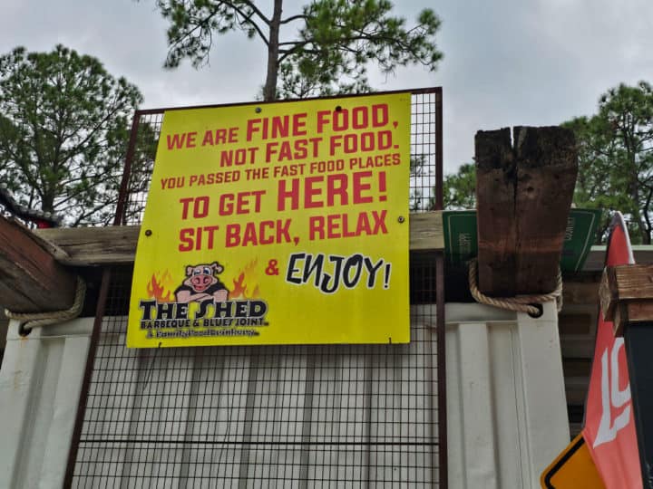 We are Fine Food not Fast Food sign with The Shed logo on it