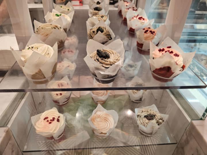 cupcakes on display on glass shelves