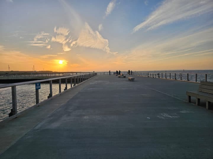 looking down the fishing pier to sunset