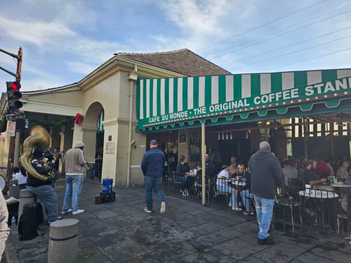 Cafe du Monde awning with musicians playing right outside of the restaurant