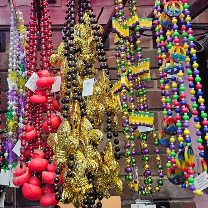 Mardi gras beaded necklaces hanging from hooks