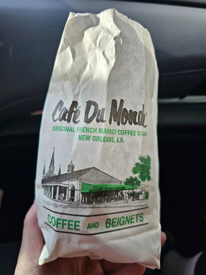 Cafe Du Monde beignets and coffee white take out bag