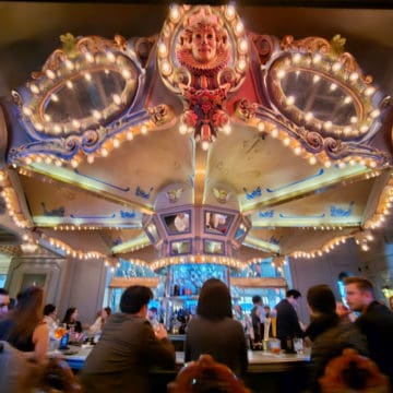 carousel bar with people sitting around it