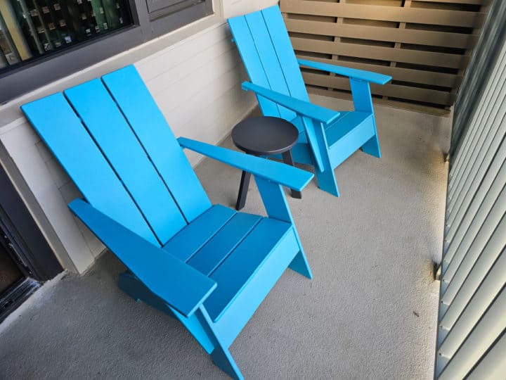 Blue Adirondack chairs on a balcony 