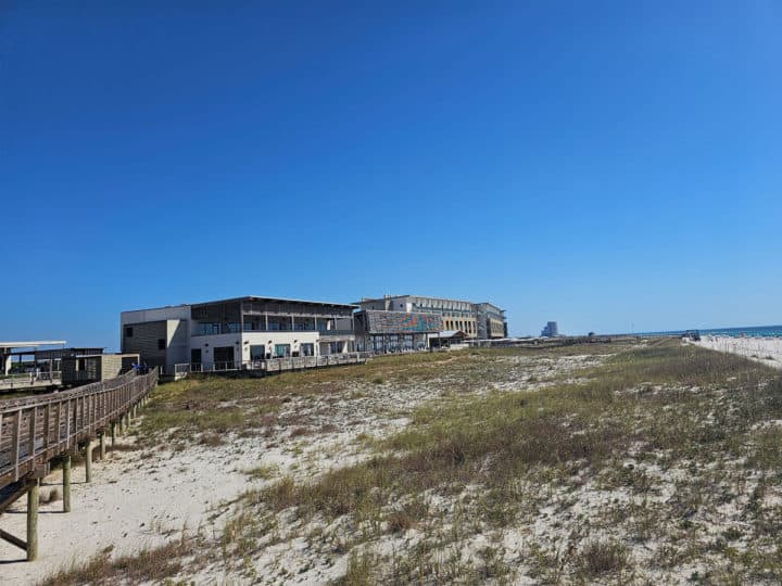 looking over sand dunes to The lodge at Gulf State Park