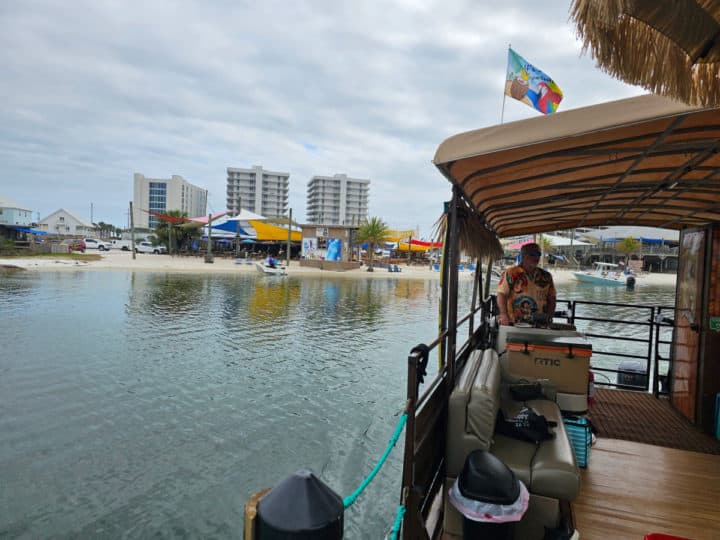 looking past the Hammock Time Tiki Tour Boat to the Flora Bama Yacht Club from the water