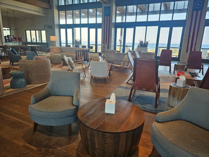hotel lobby with tables and chairs and a view of the Gulf of Mexico