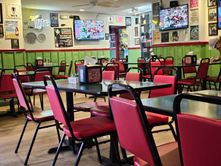 indoor seating with red chairs and art on the wall