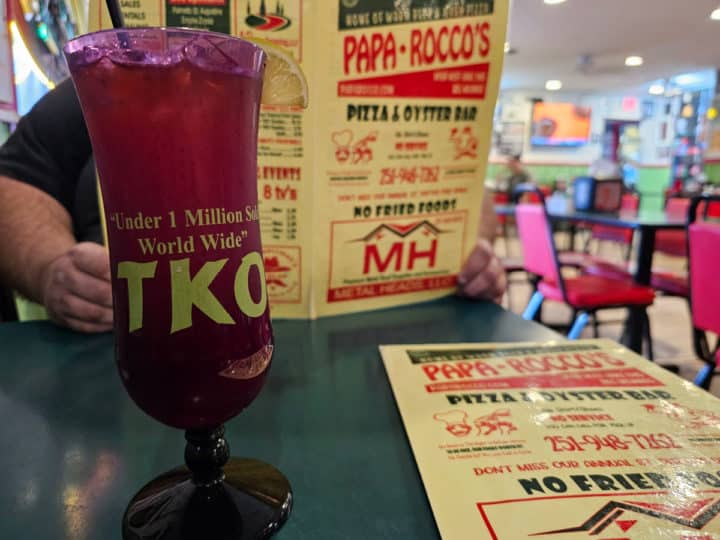 TKO Glass next to a Papa Rocco's menu on a dark table