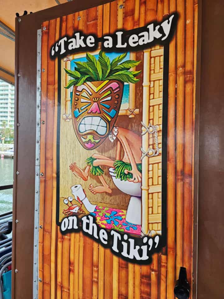 Take a Leaky on the Tiki Sign with a tiki guy sitting on a toilet and bamboo