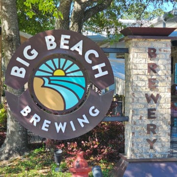 Big Beach Brewing Company sign with sun and waves.