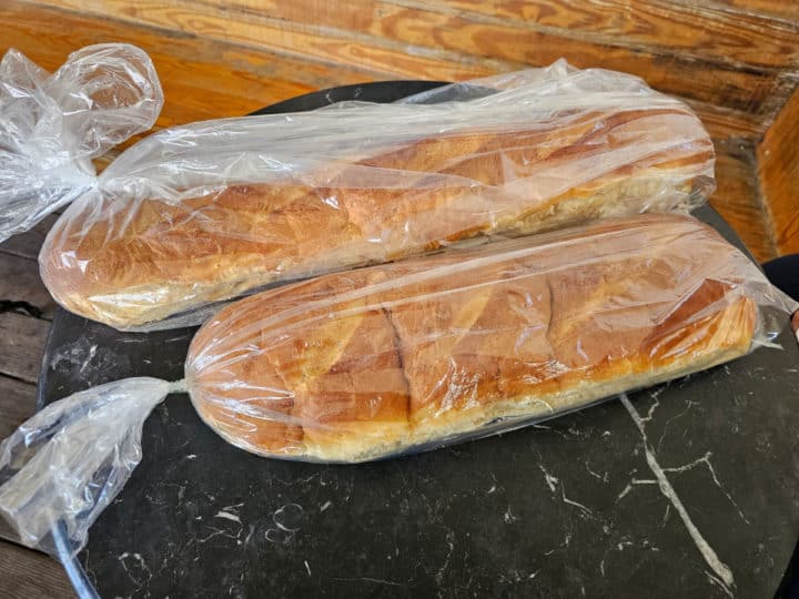 Fresh French Bread in a bags on a metal table