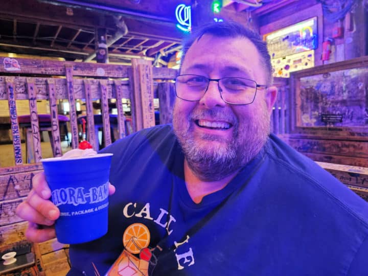John holding a blue Bushwacker Cup with a cherry on top